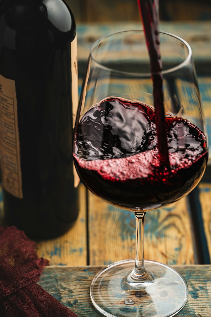 A glass of red wine mid-swirl